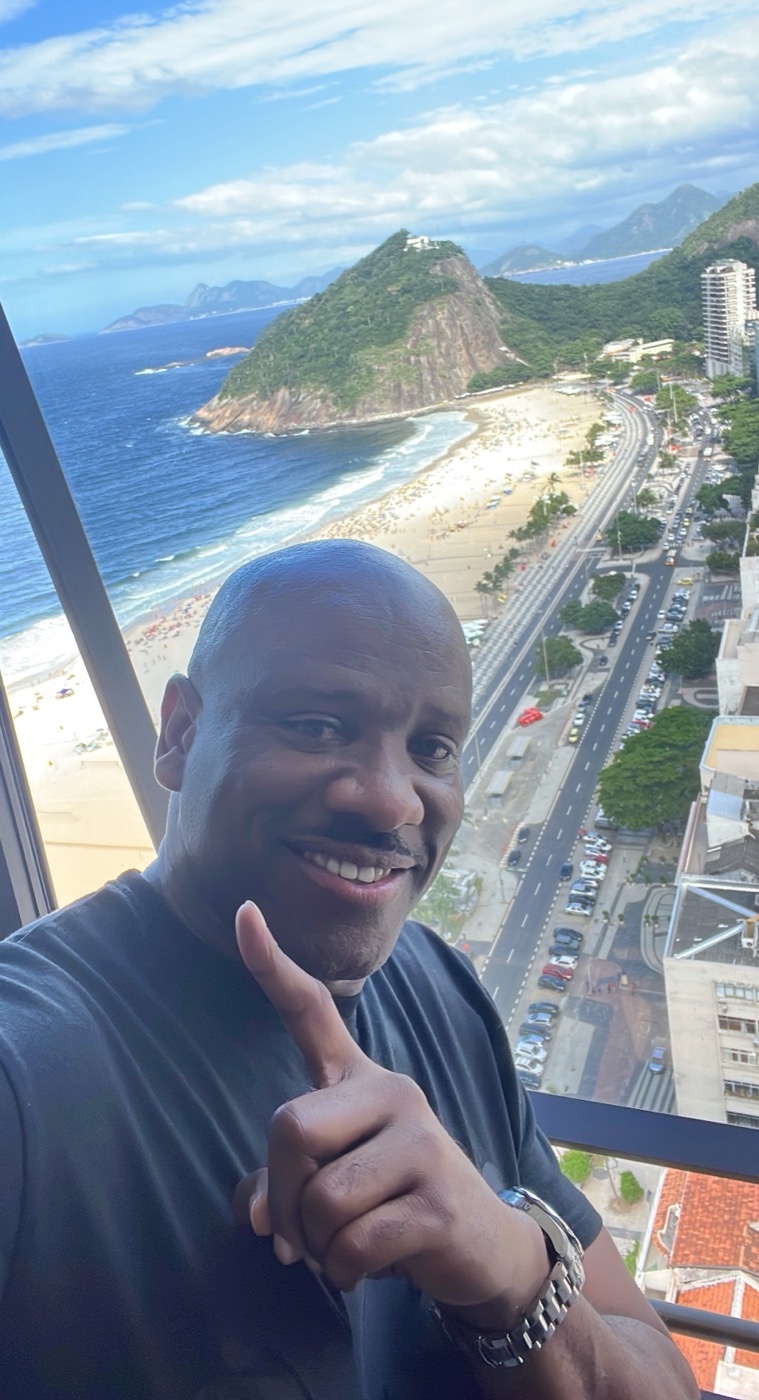 Mr. Tycoon on a balcony above the coast