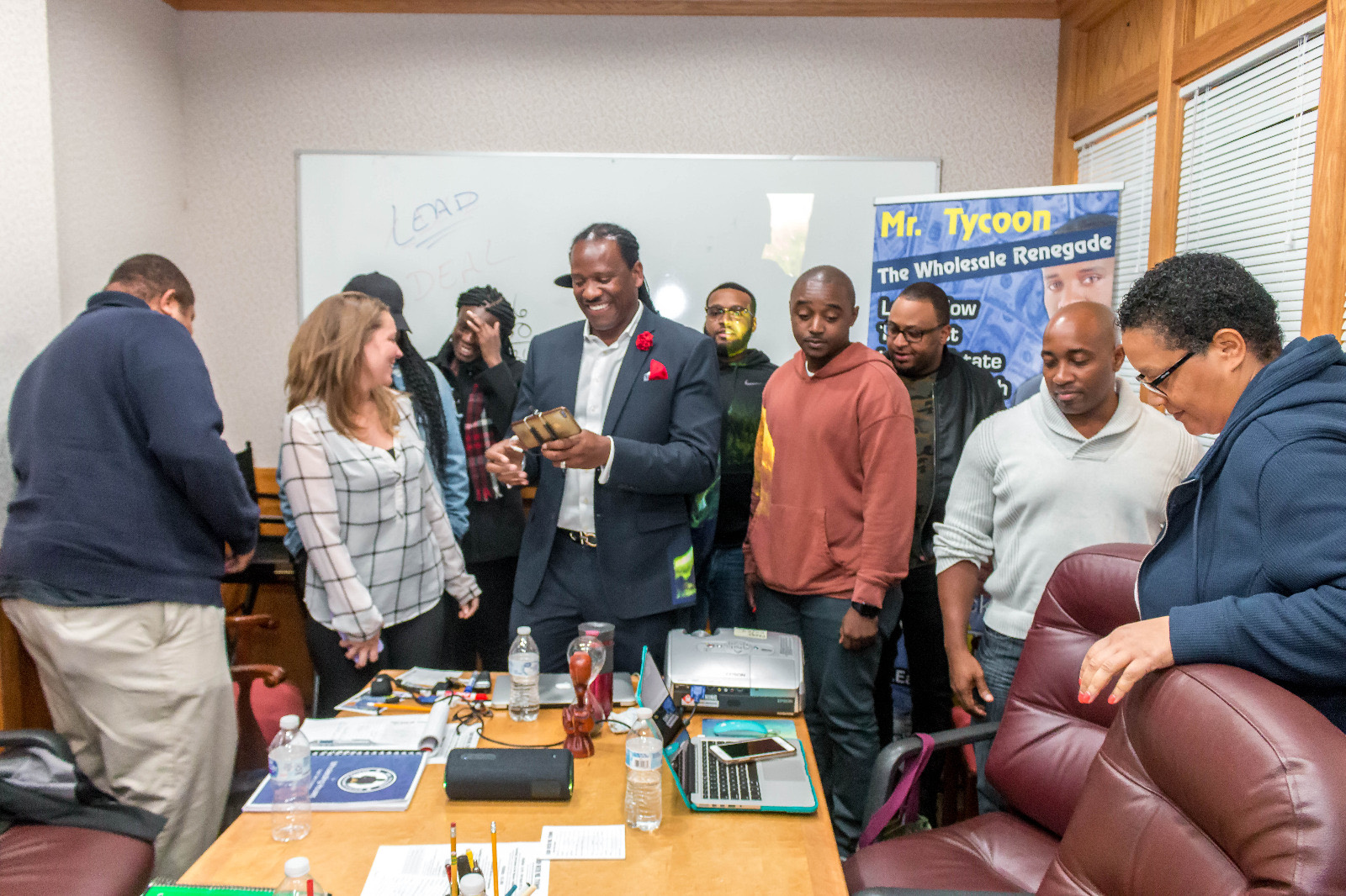 Students gathered around Mr. Tycoon at the table