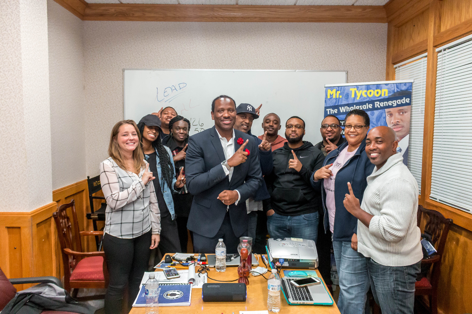The whole workshop group, thumbs up, around Mr. Tycoon